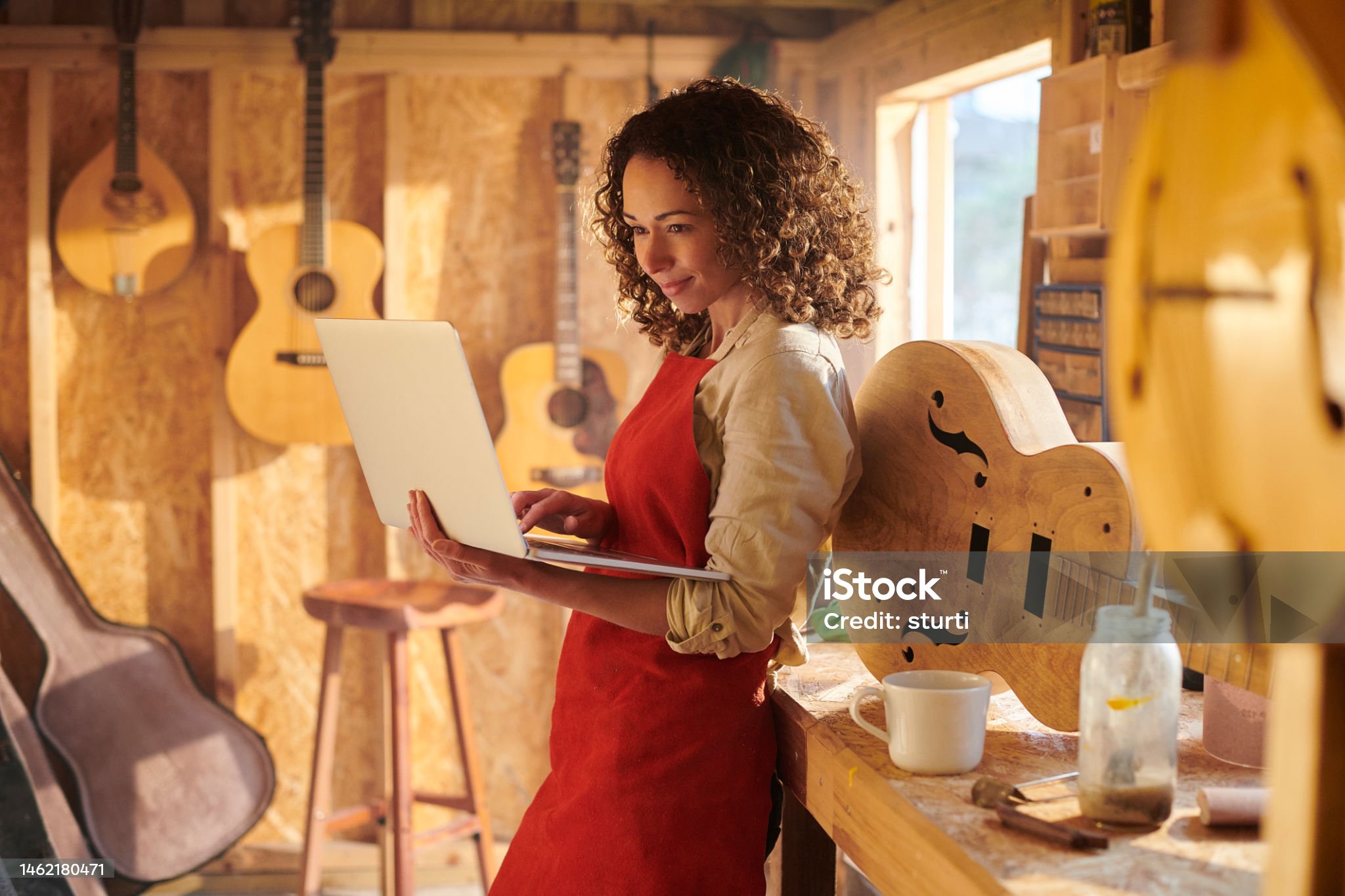 guitar maker checking her bank online